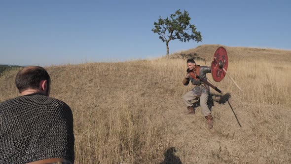 Medieval warriors throwing spears and fighting alt