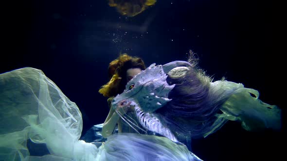 Fantasy and Dream About Underwater Fairytale World Princess and Dragon are Swimming Together alt