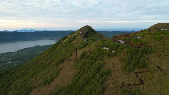 trekking paths leading to the ridge at Mount Batur volcano crater in Bali Indonesia during sunrise alt