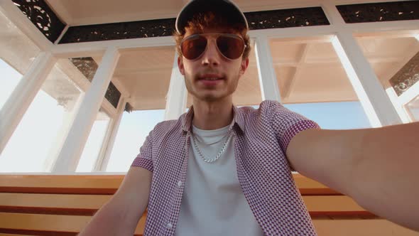 POV Man Watching Sport On Smart Phone Near Beach alt