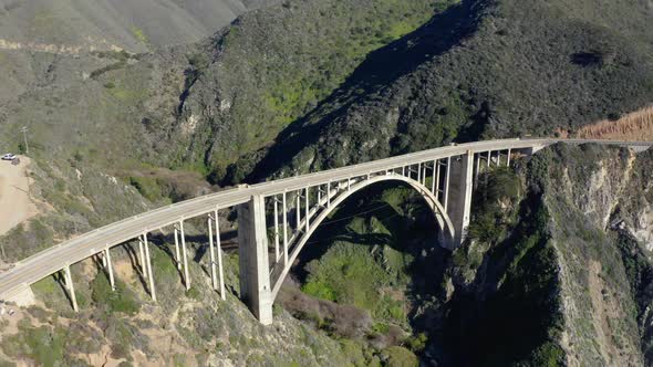 Aerial view of the picturesque arch bridge standing over the canyon.  alt