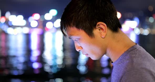 Young man looking at tablet computer alt