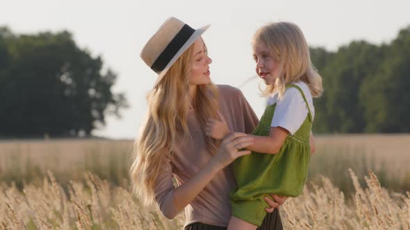 Portrait Young Beautiful Mother Blonde Woman in Straw Hat Stands in Wheat Field Holding Little alt