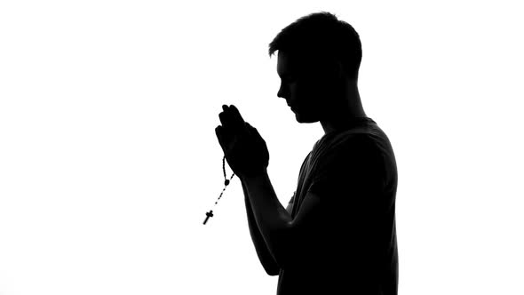 Religious Man With Rosary in Hands Praying on White Background, Spiritual Ritual alt