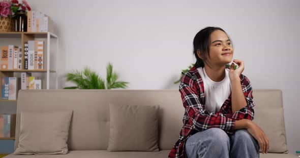 Bored girl sitting on couch and waiting her twin alt