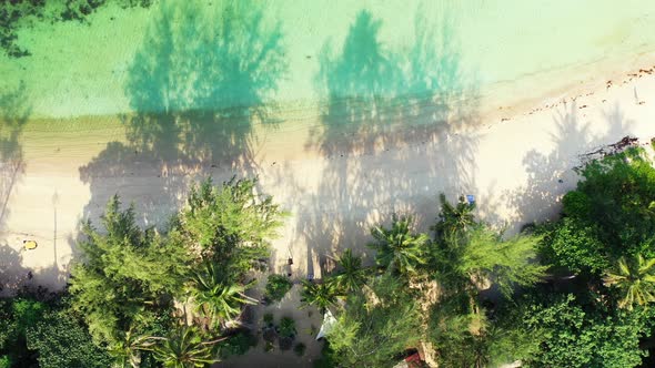 Beautiful tropical lagoon with azure sea water, secluded sandy beach and palms. Aerial alt