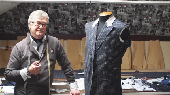 Professional Mature Tailor Working on His New Classical Suit Using Tailor's Dummy at His Workshop alt
