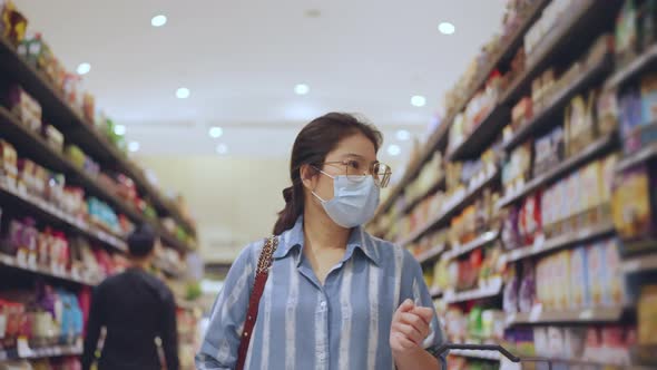 Asian female woman wearing protective face mask hand choosing fresh product