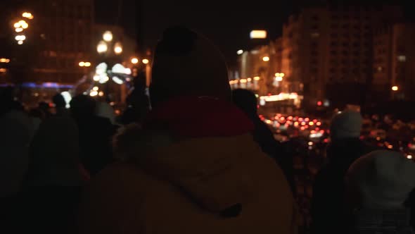 A Guy in a Yellow Jacket Walks in the City Center at Night in the New Year