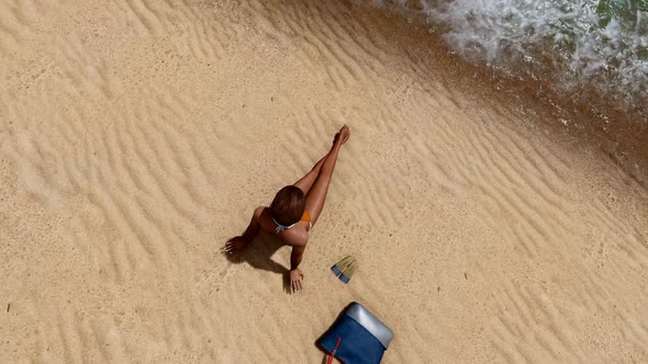 Woman Sunbathing at the Beach alt