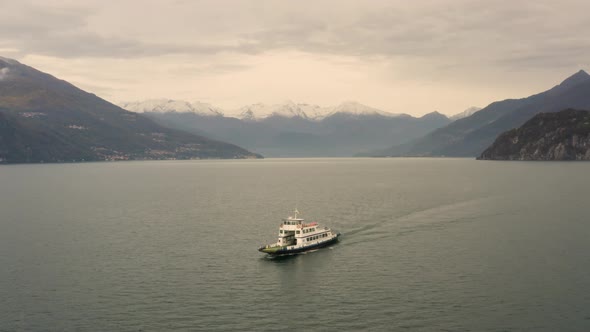Aerial view of single ferry boat crossing Lago di Como, Cadenabbia, Italy. alt