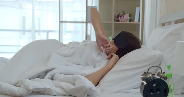 Asian young woman wake up late with alarm clock