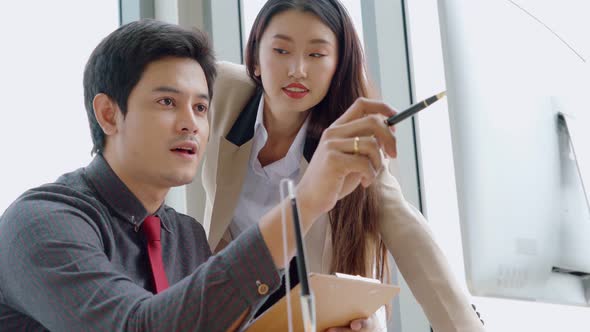 Two Business People Talk Project Strategy at Office alt