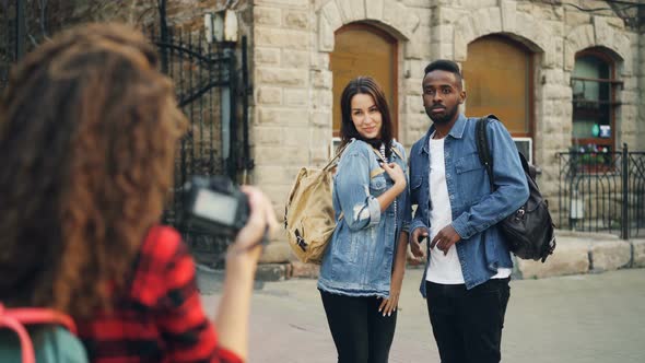 Creative Girl and Guy Friends Are Posing for Camera Standing in the Street While Young Woman with alt