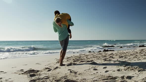 Couple in love enjoying free time on the beach together alt