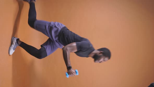 Athletic Darkskinned Man Training with Dumbbells Isolated Background