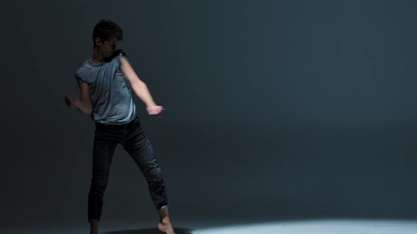 Emotional Performance of Man Dancing Modern Ballet on Gray Studio Background alt