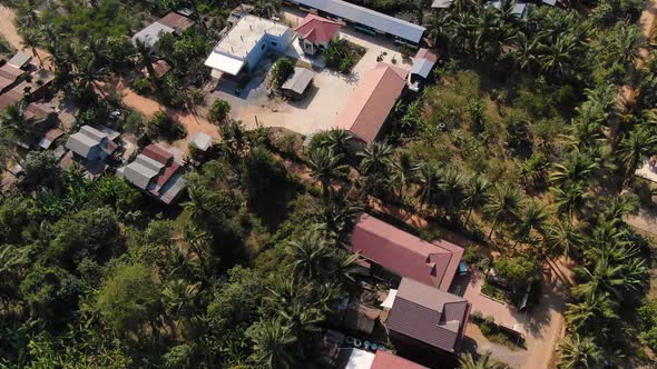 Aerial overview of school buildings and community during a sunny breezy day in Battambang Cambodia alt