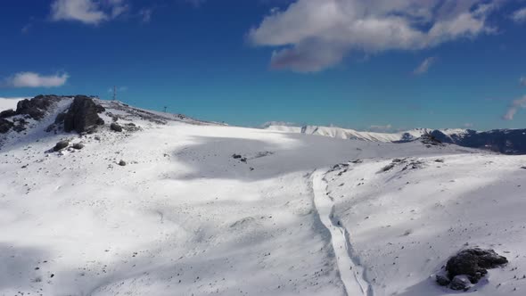 Aerial view at the ski slopes on a sunny winter day