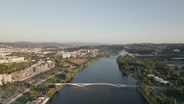 River Mondego and Rainha Santa Isabel bridge in background, Coimbra in Portugal. Aerial forward