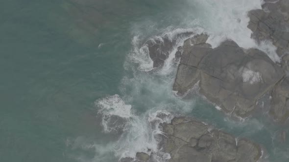 Waves Crash Against Rocks in the Ocean