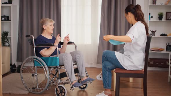 Rehabilitation Treatment for Handicapped Old Woman alt