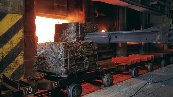Smelting Chamber with Compressed Metal Getting Loaded Into It alt