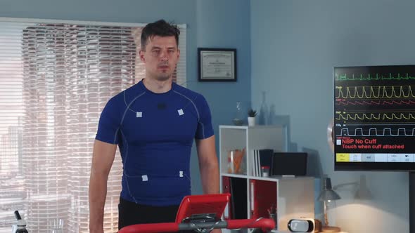 Middle Closeup of Athlete Changing Treadmill Speed During Cardiac Stress Test in Lab alt