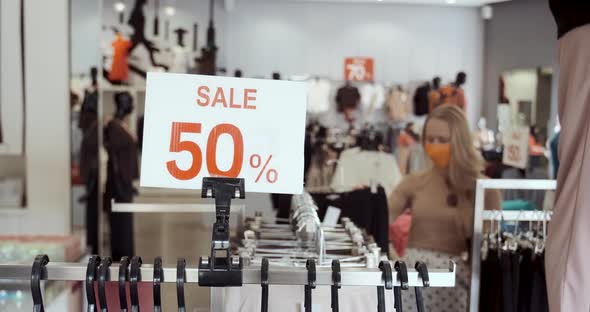 Clothing Store Banner with Discount Amount and People in Masks Choosing Clothes