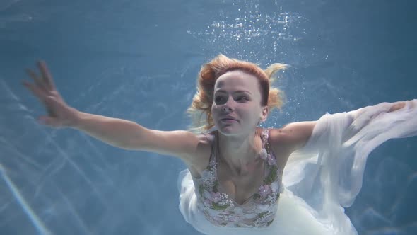 Woman Swimming Underwater in the Swimming Pool