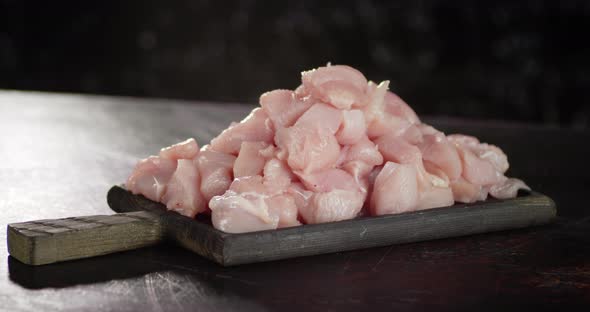 A Bunch of Raw Chopped Chicken Fillet Rotates Slowly. alt