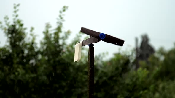 Black Handmade Windmill Rotates After Rain Under Grey Sky