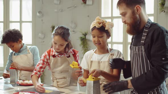 Kids Grating Cheese during Cooking Masterclass alt