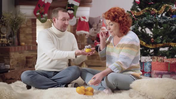 Smiling Caucasian Man Proposing To Excited Woman on New Year's Eve at Home alt