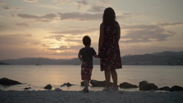 Mom with Son By the Sea While Relaxing alt