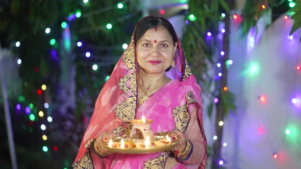 A Women Lighting a Lamp