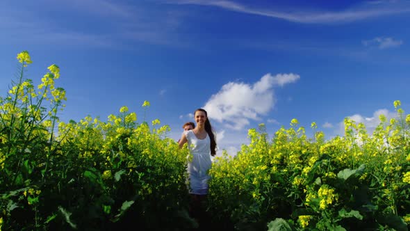 Romantic couple holding hands while walking in field alt