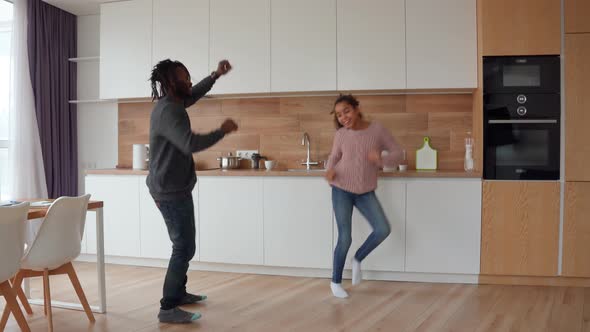 Active Happy African American Family Jumping Dancing and Having Fun at Home alt