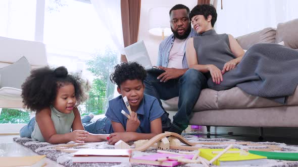Happy African American family is enjoying spending leisure time together at home during lockdown