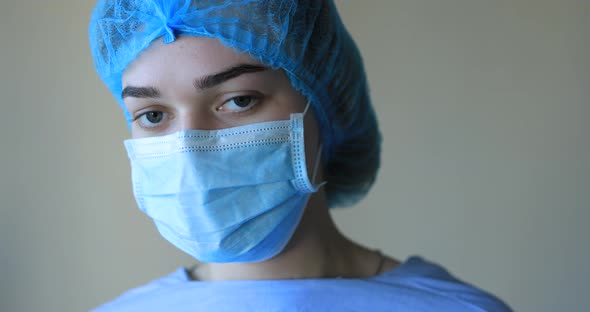 Female Doctor in Protective Face Mask and Medical Hat
