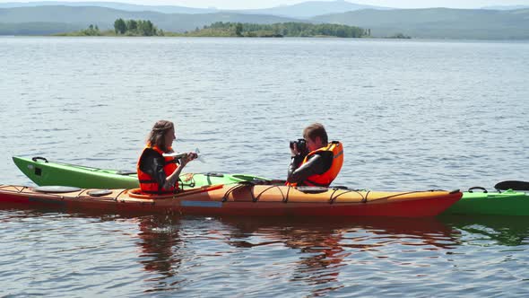 Tourists Photographing in Kayak alt