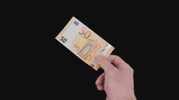 Male Hand Shows a Banknote of 50 Euros with Alpha Channel alt