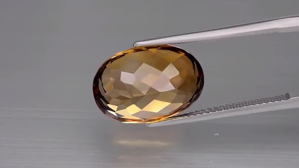 Imperial Champagne Yellow Topaz Oval Cut in the Turning Tweezers
