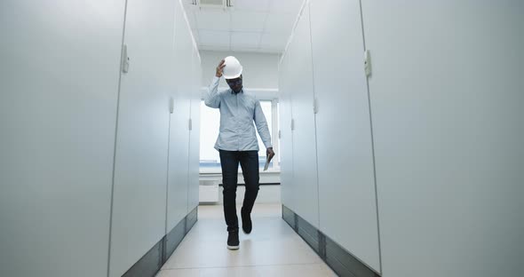 An Engineer Puts on a Helmet alt