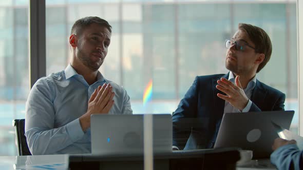 Applauding colleagues for corporate leader in meeting room alt