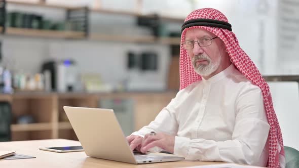 Senior Old Arab Businessman with Laptop Smiling at Camera alt