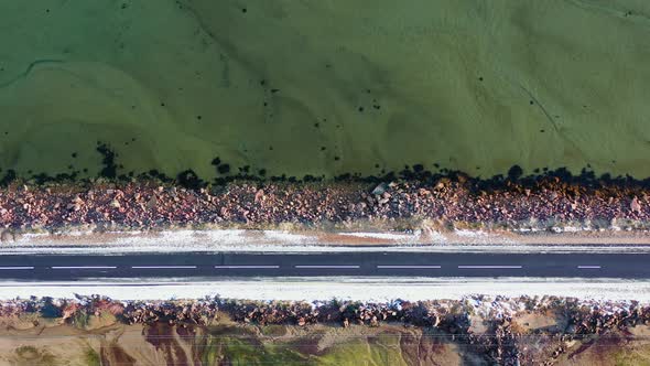 Empty asphalt road near the sea. Cinematic aerial landscape. Copy space.	
