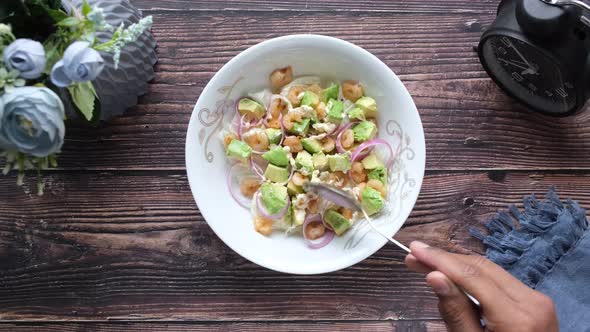 Young Women Eating Avocado Salad alt