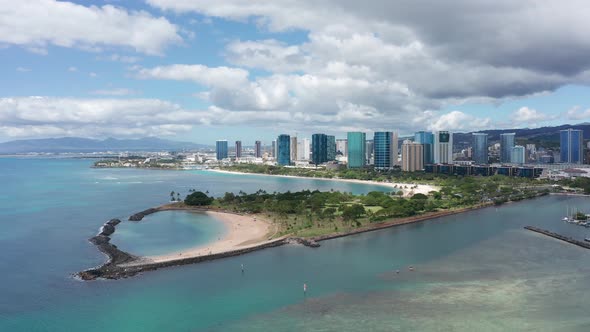 Descending close-up aerial shot of Magic Beach in Honolulu on the island of O'ahu, Hawaii. 4K alt