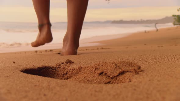 Boy with Bare Feet Leaving his Footprints on the Sand of a Tropical Beach
